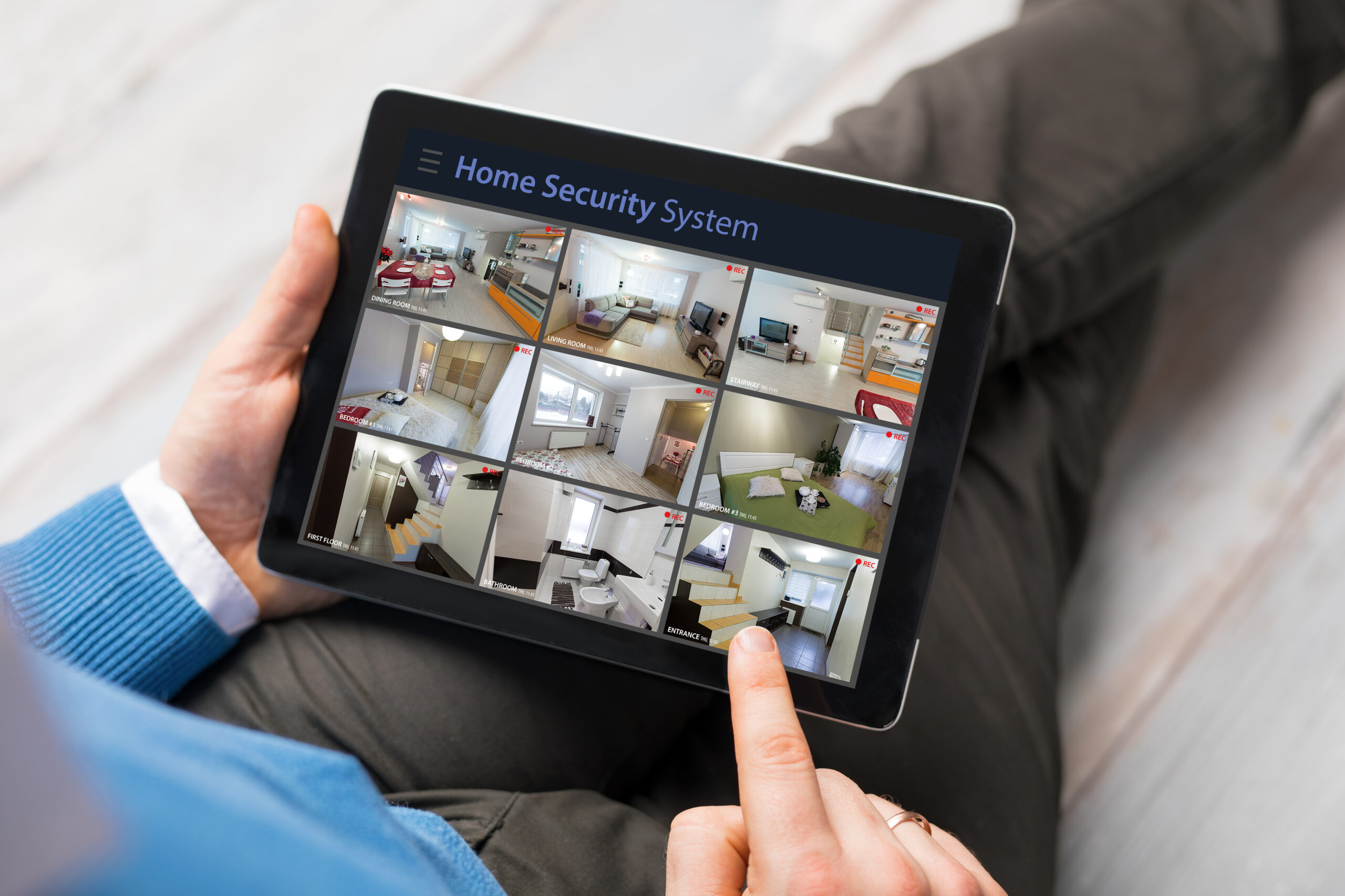 man looking home security cameras tablet computer